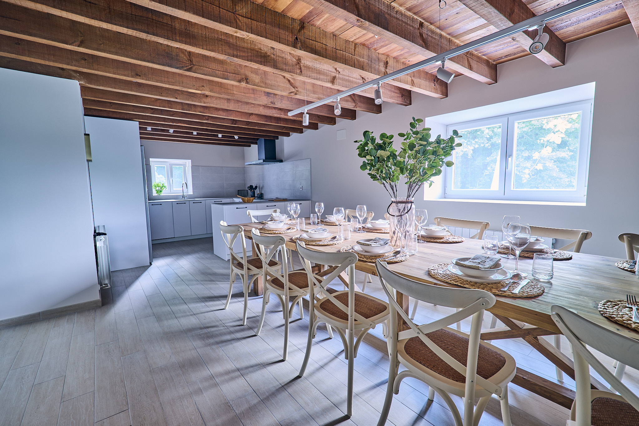 Photo: open dining & kitchen, exposed beams
